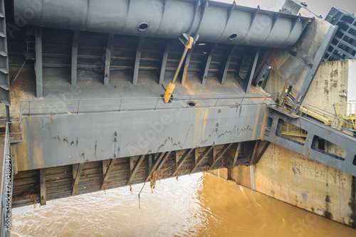 Hydraulic water gate is shifting up to allow water flow through in the rainy season. The Pak Mun Dam is run-of-the-river hydroelectric plant of the Mun river in Ubon Ratchathani Province, Thailand. photo