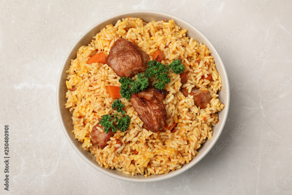 Bowl with delicious rice pilaf on light background, top view Bowl with delicious rice pilaf on light background, top view