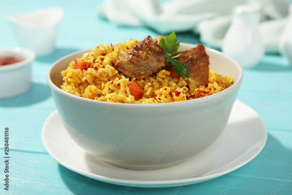 Bowl of tasty rice pilaf with meat on table Bowl of tasty rice pilaf with meat on table
