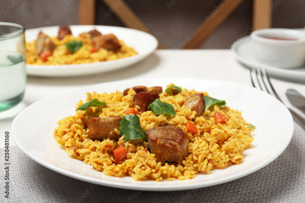 Plate of delicious rice pilaf with meat on table Plate of delicious rice pilaf with meat on table