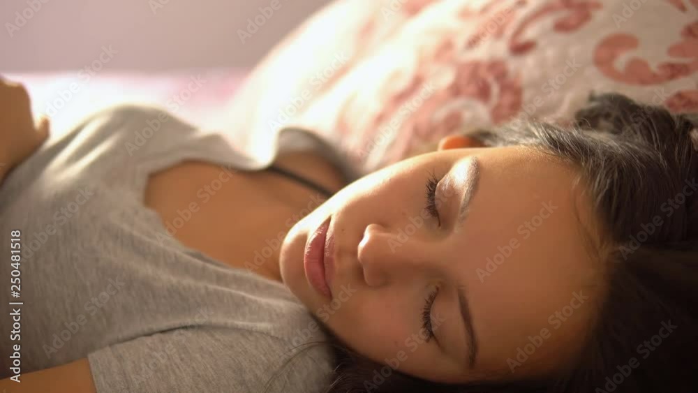 Desperate girl suffering insomnia trying to sleep in a bed at home Desperate girl suffering insomnia trying to sleep in a bed at home