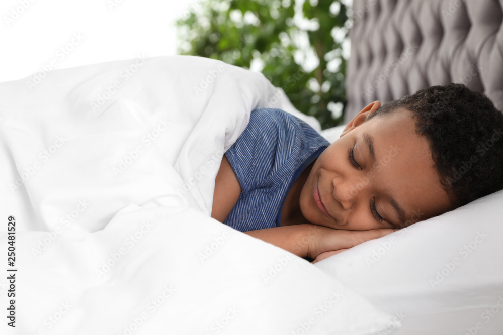 Cute little African-American boy sleeping in bed Cute little African-American boy sleeping in bed