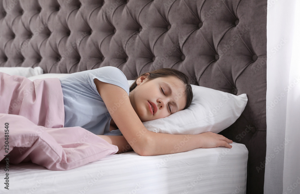 Beautiful little girl sleeping in bed at home