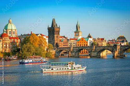 Scenic view on Vltava rive, Charles bridge and historical center of Prague, buildings and landmarks of old town at sunset, Prague, Czech Republic