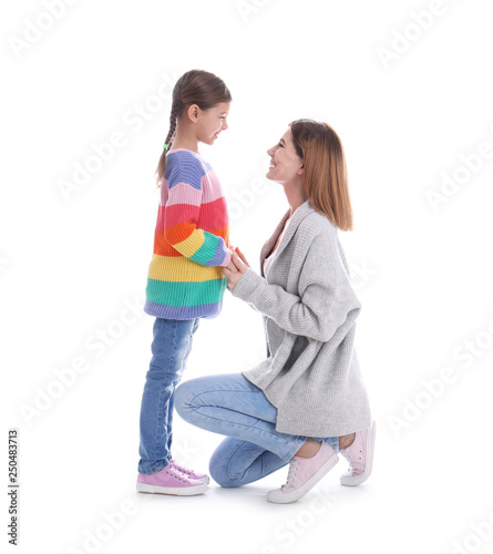 Happy woman and daughter in stylish clothes on white background