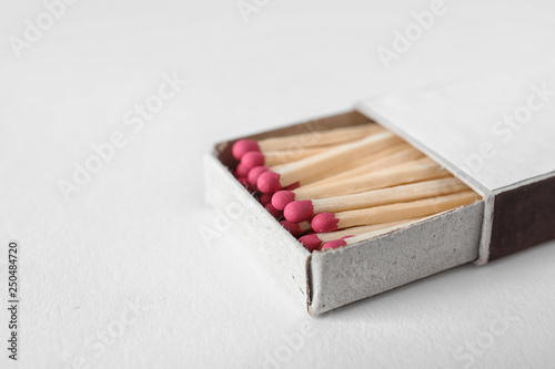 Cardboard box with matches on light background