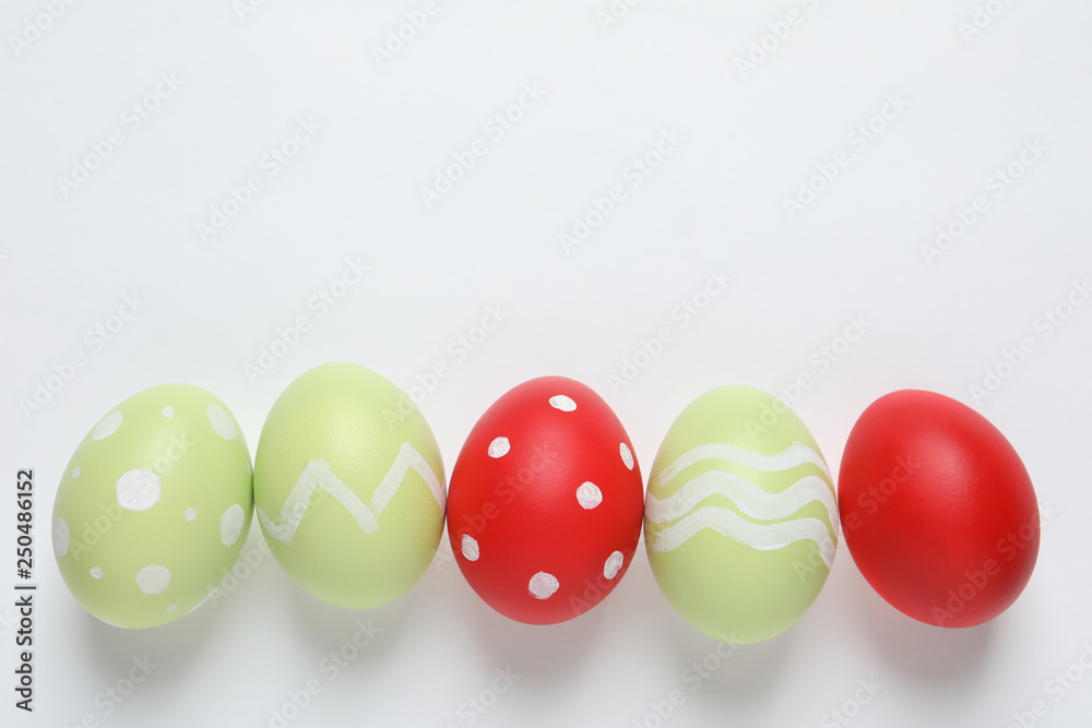 Flat lay composition of painted Easter eggs on white background Flat lay composition of painted Easter eggs on white background