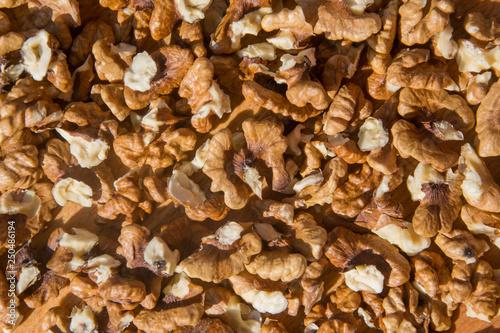 Closeup of Peeled Walnuts pile. Walnuts Background on wooden cutting board. Selective Focus, nuts with many different textures