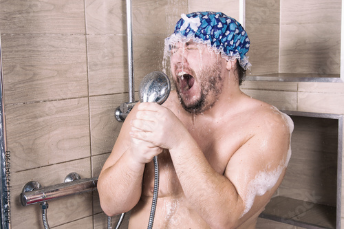 Funny fat man sings in the shower. 