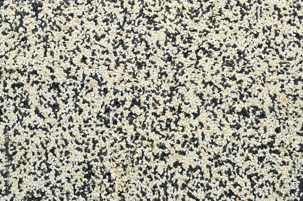Set of black and white sesame seeds. On a white background. Top view. Free copy space. Set of black and white sesame seeds. On a white background. Top view. Free copy space.