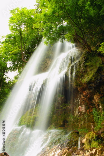 Summer waterfall in forest.