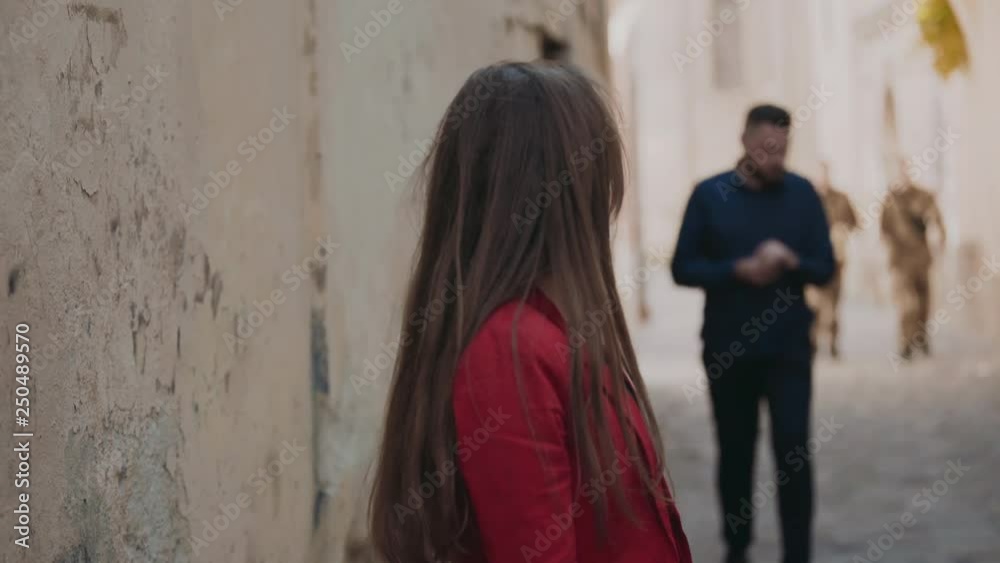 The frightened girl confusedly goes on the street and turns back The frightened girl confusedly goes on the street and turns back