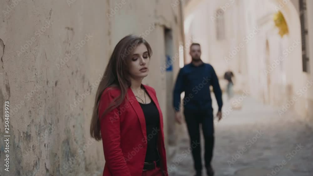 The frightened girl confusedly goes on the street and turns back The frightened girl confusedly goes on the street and turns back