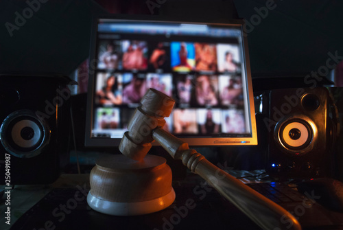Hammer on the background of the computer screen, illegal site with adult content,