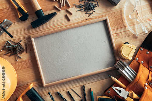 Empty picture frame as copy space on carpentry woodwork desk