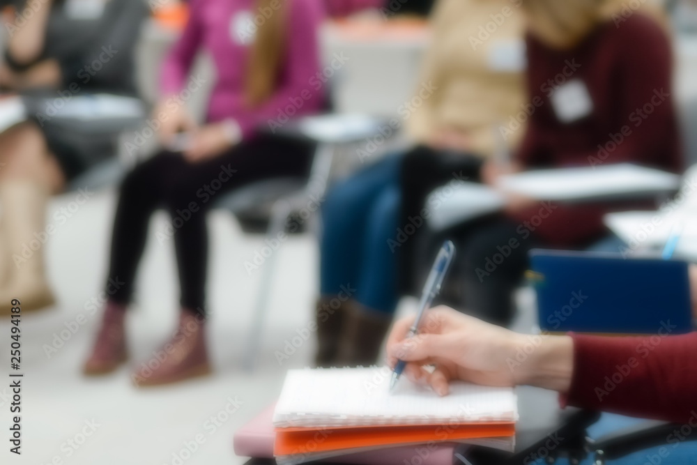A woman sits at a lecture, presentation. A woman sits at a lecture, presentation.