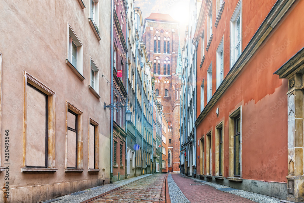 Narrow Polish street and the Dome of the Church of St Mary's in Gdansk, Poland