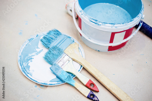 a bucket of paint and a paint tray and roller brush set