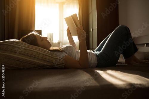 Girl lies and reads a book