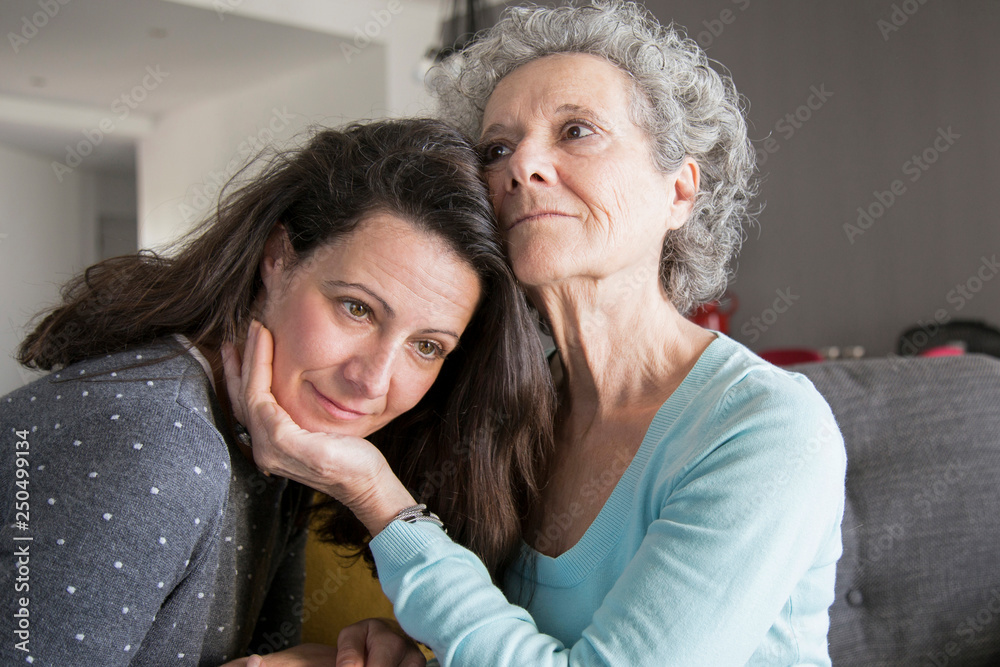 Content elderly woman and her daughter embracing Content elderly woman and her daughter embracing