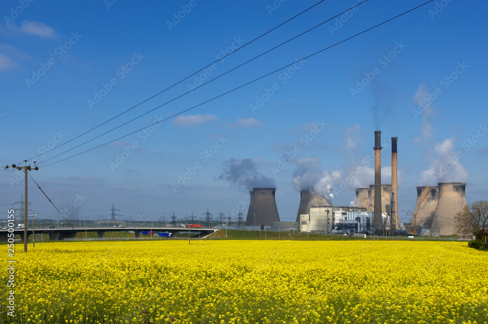 FERRYBRIDGE POWER STATION AND M62 MOTORWAY NEXT TO FIELD OF RAPESEED, ENGLAND, UK