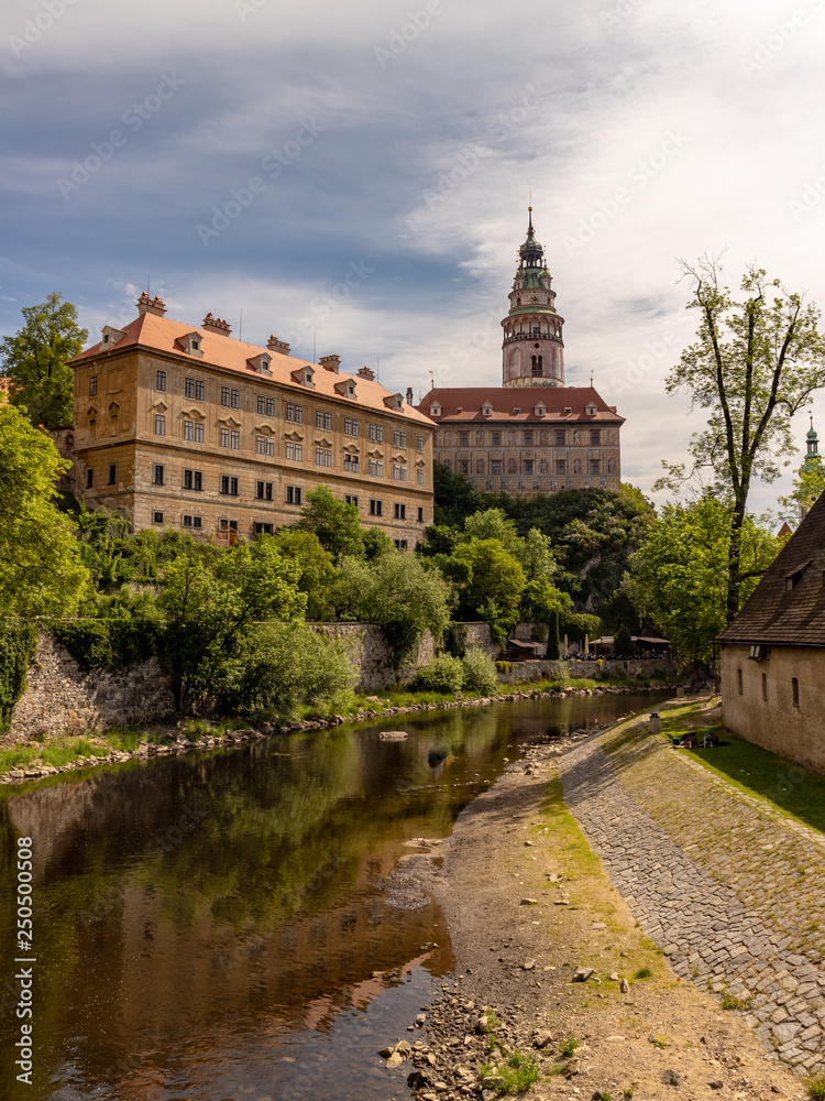 View of the Unesco World Heritage City Cesky Krumlov in the Czech Republic with historic buildings, churches and narrow streets in front of blue sky