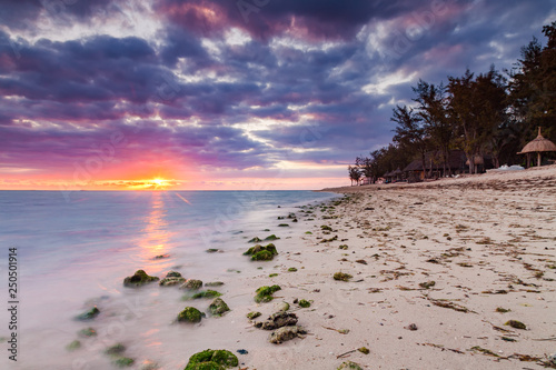 Beautiful sunset on the beach in a tropical resort at Reunion island.