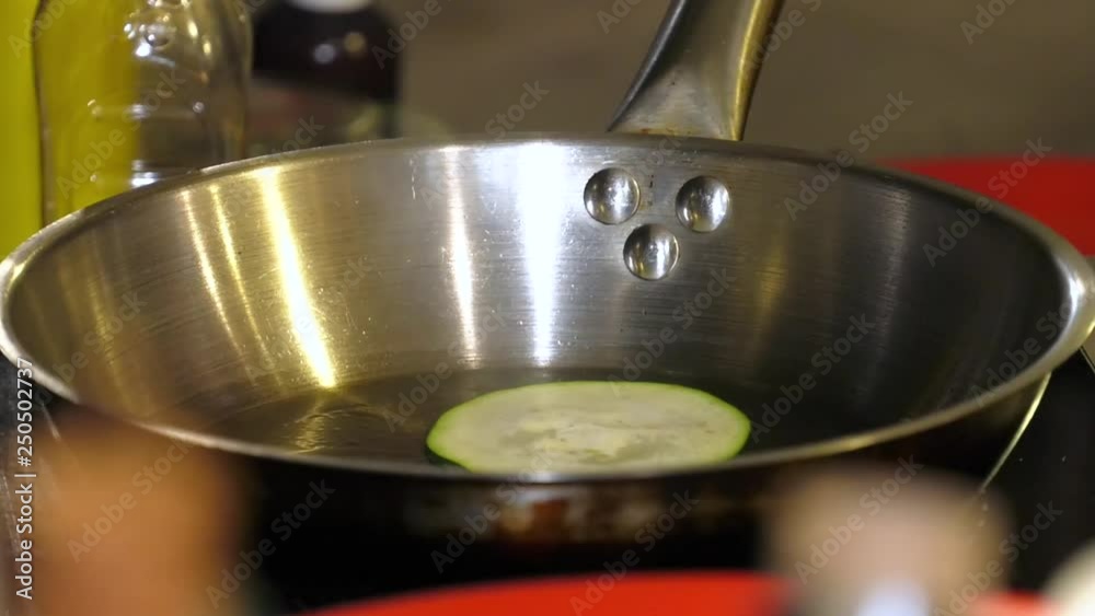 Delicious and healthy food. Fry zucchini in a heated pan. Cook puts a thin slice of zucchini. Seafood salads. Recipe. Delicious and healthy food. Fry zucchini in a heated pan. Cook puts a thin slice of zucchini. Seafood salads. Recipe.