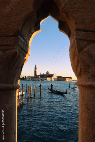 view of the basilica San Giorgio Maggiore ( 16th-century benedictine church on the island of the same name in Venice ) through the bridge fence, Italy © irisphoto1