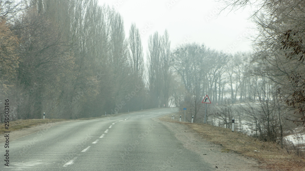 Morning country road in early spring with a haze on the horizon Morning country road in early spring with a haze on the horizon