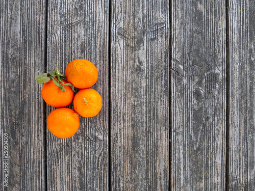group of tangerines on wood background top down view