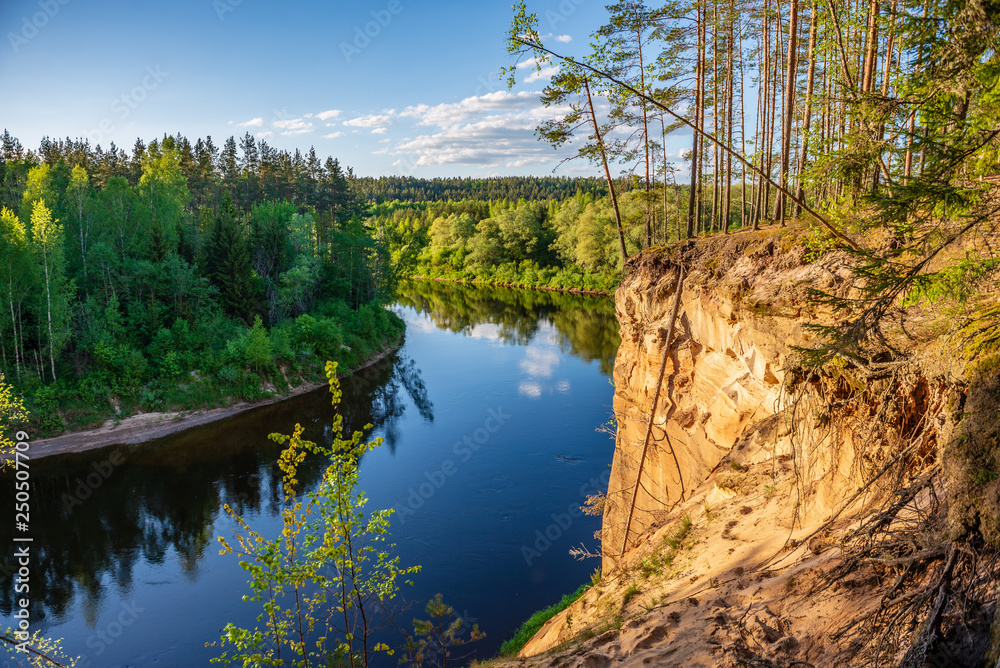 sandstone cliffs on the shore of forest river sandstone cliffs on the shore of forest river