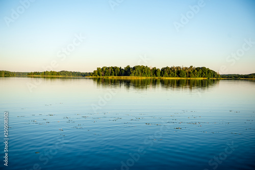 calm weather sunset on country lake © Martins Vanags