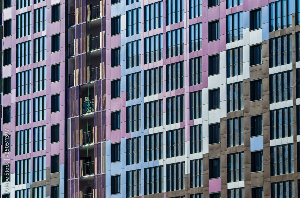Facing the building with a ventilated facade. Aluminum colored facades. Modern facades of high-rise buildings. Construction of a large residential complex.