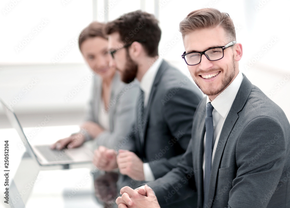 Fototapeta premium side view. smiling businessman on the background of the workplace