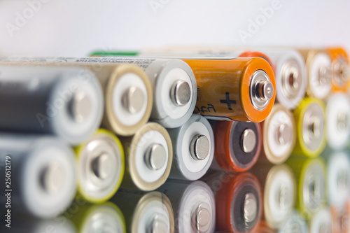 alkaline AA batteries on the glass surface with close-up reflection, salt batteries, accumulators