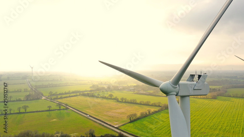 Fotografie, Obraz Aerial photo of wind turbines at sunset in Sainte Pazanne, France