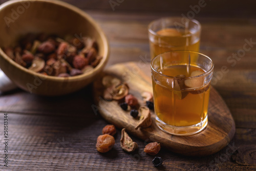 Compote of dried fruits and assorted dried fruits in wooden bowl .