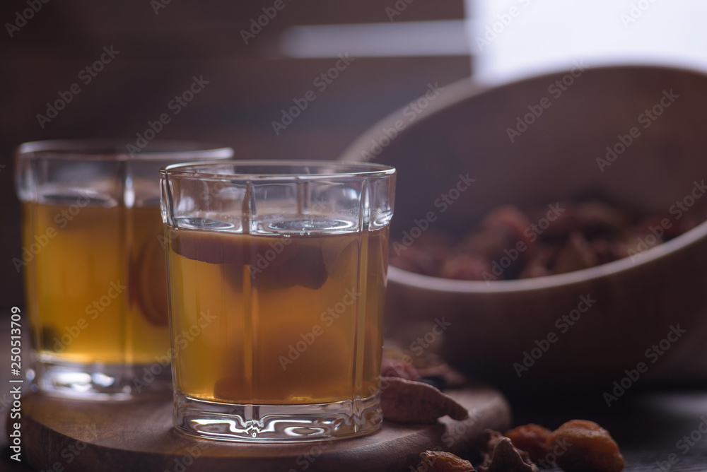close-up of compote in glasses with a wooden bowl filled with assorted dried fruits close-up of compote in glasses with a wooden bowl filled with assorted dried fruits