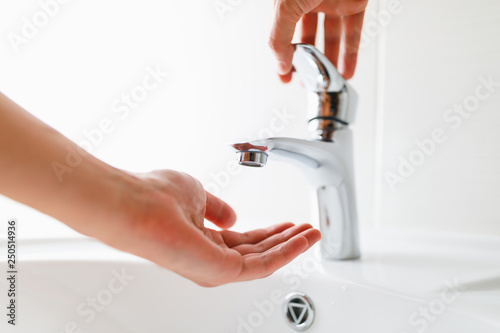 hand under faucet without water photo