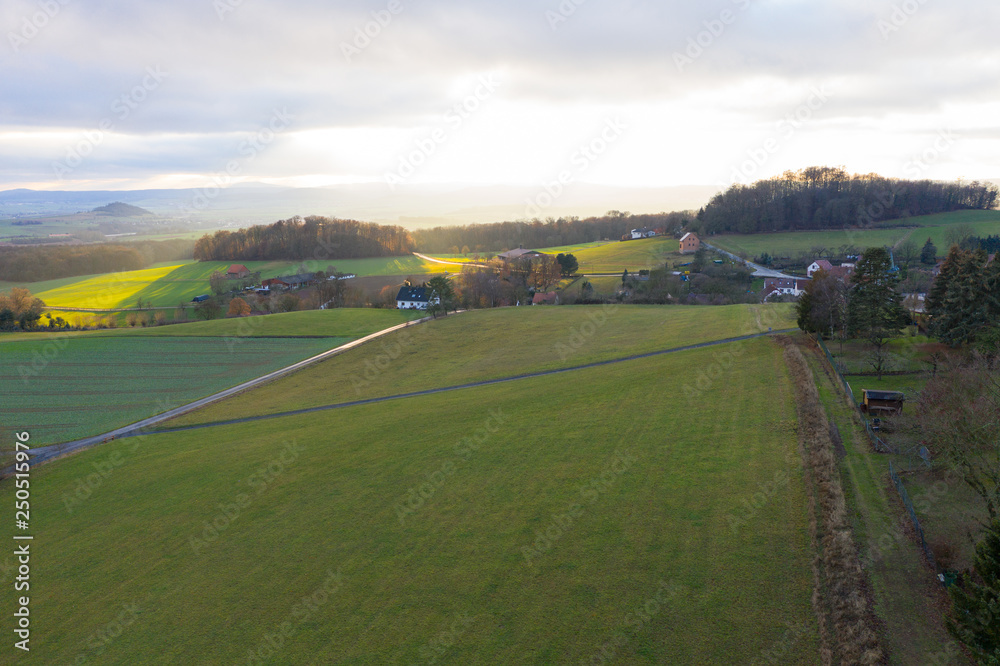 village from above in the countryside of germany with hills and forrest village from above in the countryside of germany with hills and forrest