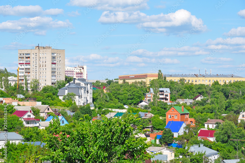 Obraz premium City view with private and high-rise buildings in summer