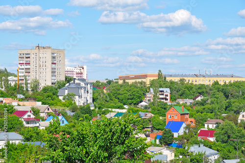 City view with private and high-rise buildings in summer
