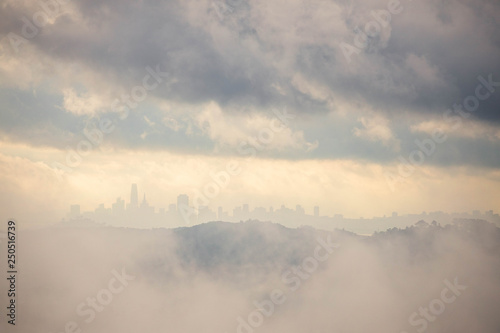 San Francisco skyline visible through mix of fog and clouds from the Marin Headlands
