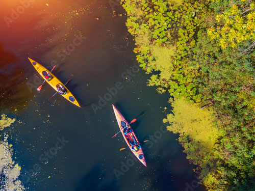 Vászonkép Aerial drone bird's eye view photo of Happy family with two kids enjoying kayak ride on beautiful river