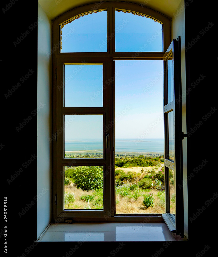 View of blue sky and sea from window View of blue sky and sea from window