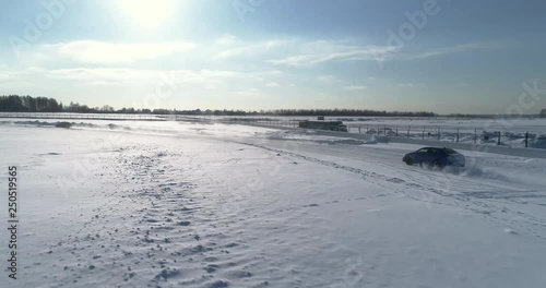 Blue and black subaru wrx racing on the ice ring, aerial view photo