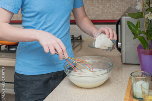 teenage boy cooking at home.