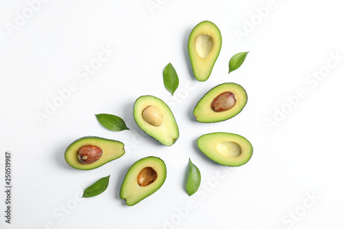 Flat lay composition with ripe avocados on white background, space for text. Top view photo