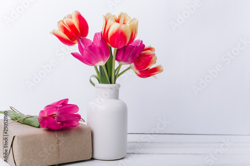 Mother s day composition.Vase with tulips and gifts